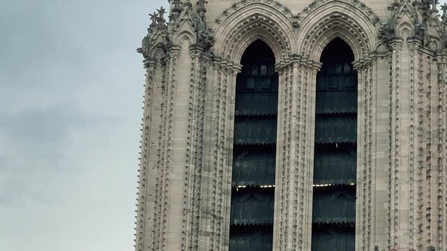 On a cloudy day in Paris, Notre-Dame Cathedral currently undergoing restoration following the fire is once again the site of ongoing architectural restoration work.