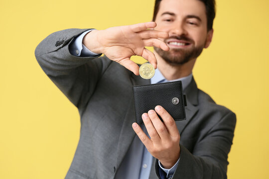 Cryptocurrency investment and digital finance, businessman putting bitcoin coin into a leather wallet for wealth management and online banking security