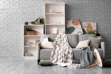 Home chaos and mental health struggle, messy living room with overturned furniture and disarray reflecting stress and domestic disorder in modern home © Pixel-Shot