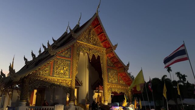Illuminated Buddhist temple at dusk in Chiang Mai