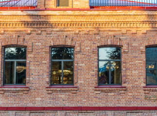 Three windows of the old mansion 19 century with brown bricks wall © Dmitrii Potashkin