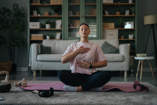 Woman practicing mindfulness and breathing exercise at home