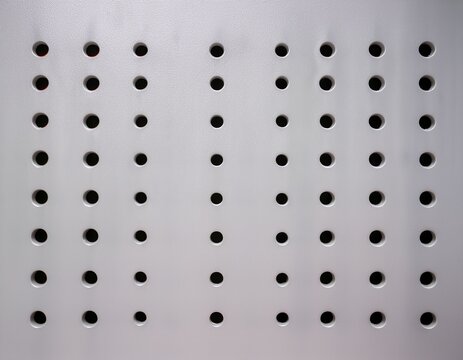straight on view of pegboard wall with uniform holes minimal surface for storage organization and display clean geometric pattern background for workshop studio retail or interior design use