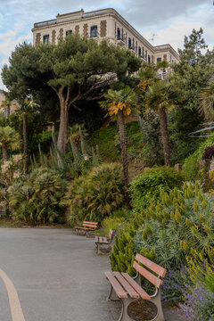 Urban park in Dinard, Brittany, landscape design, flowers, lush greenery, and picturesque pathways surrounded by historic French charm