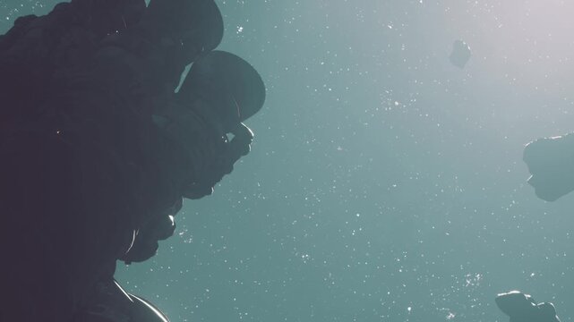 A group of statues stands submerged in water with bubbles rising around them. Light filters through the surface, creating a unique view under the sea. Time is midday.