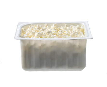 cottage cheese in a plastic box isolated on white background. Plastic tray of cottage cheese isolated on white background.