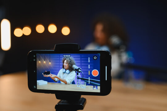 Vlogger presenting new smartphone during online broadcast recording video review