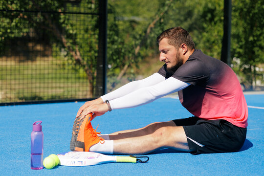 Padel Player Stretching Before Match for Sports Injury Prevention