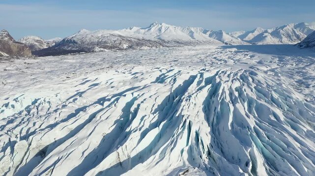 Panoramic View of Frozen Glacier Field with Deep Blue Fissures and Polar Landscape