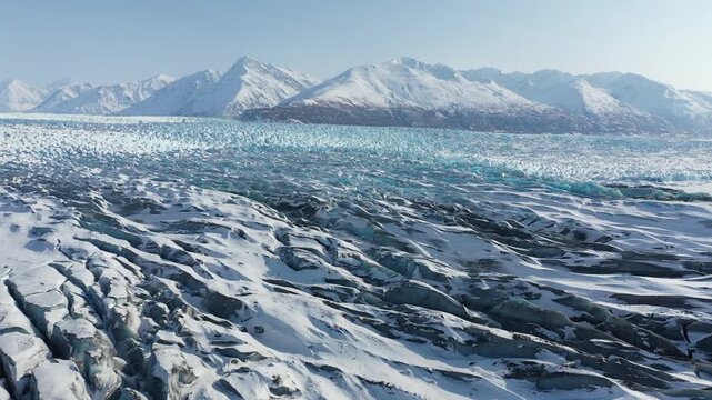 Panoramic View of Frozen Glacier Field with Deep Blue Fissures and Polar Landscape