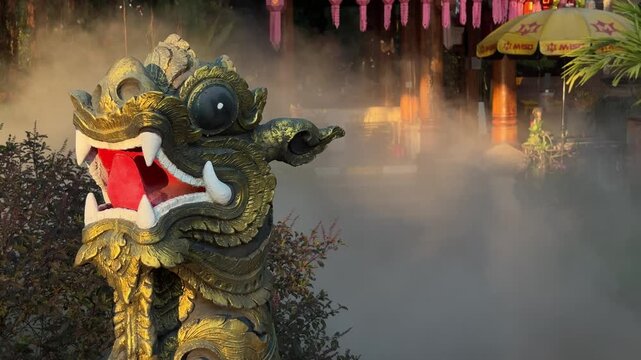 Temple guardian statue with water smoke in Chiang Mai