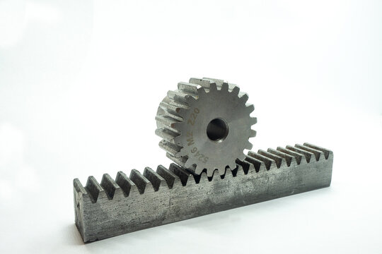 A steel spur gear resting on a matching rack gear