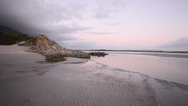 sunset light and dusk falling upon Grotto Lagoon and rock formations, Hermanus, South Africa