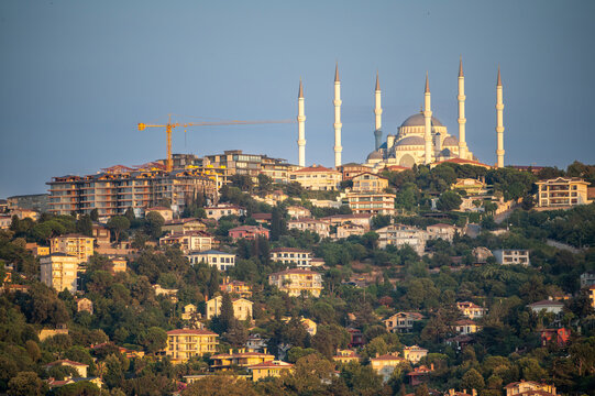Istanbul,turkey,august 4, 2025. Camlica mosque architecture and minarets rising above a residential hillside with houses, trees, and city expansion construction