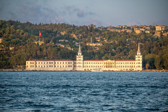Istanbul,turkey,august 4, 2025. Kuleli military high school on the bosphorus shore in istanbul, historic waterfront landmark framed by lush green hillside and summer sky