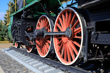 Red Big Wheels of Vintage Steam Locomotive Train on Steel Railway Track for History and Transport Concept © yaviki