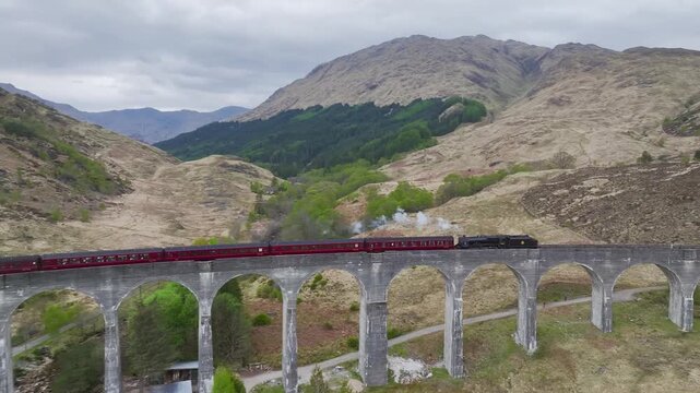 The Jacobite Steam Train on Glenfinnan Viaduct from a drone, Loch Shiel, Glenfinnan, River Finnan, West Highland, Scotland, United Kingdom