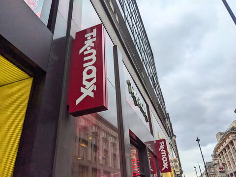 Vibrant red TK Maxx store sign and glass facade on the iconic Oxford Street in central London