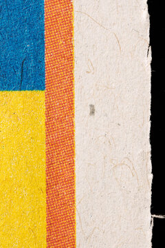 Blue and Yellow Print Beside a Torn Paper Edge