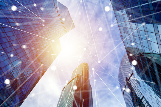 Business technology, modern office skyscrapers connected by a digital network represent smart city infrastructure, communication and corporate innovation.