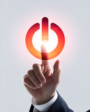 Close up of businessman finger touching glowing red and orange power button symbol representing initiation startup activation and control.