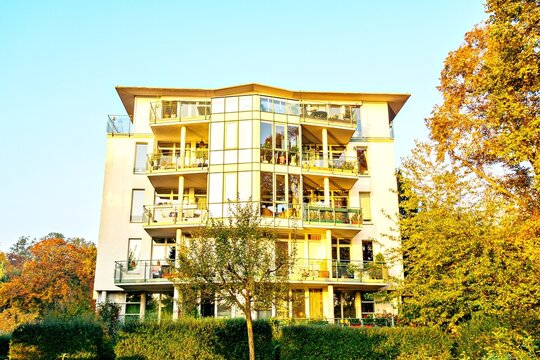 Modern apartment building with balconies and trees