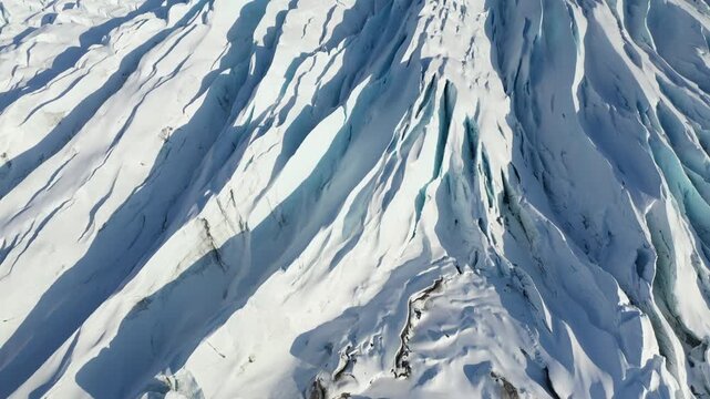 Drone Flyover Above Textured Glacier Ice Fissures in Polar Landscape