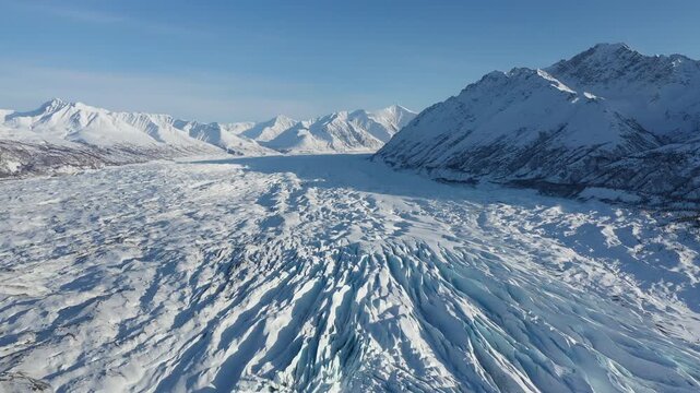 Panoramic Drone Flyover Above Deep Blue Glacier Crevasses in Polar Landscape