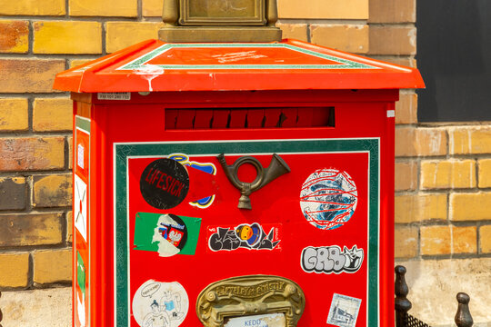 Red Hungarian postbox mailbox letter box, national Hungarian postal communication service, Magyar Posta logo, delivery business institution, traditional mail Budapest, Urban district Budapest, Hungary