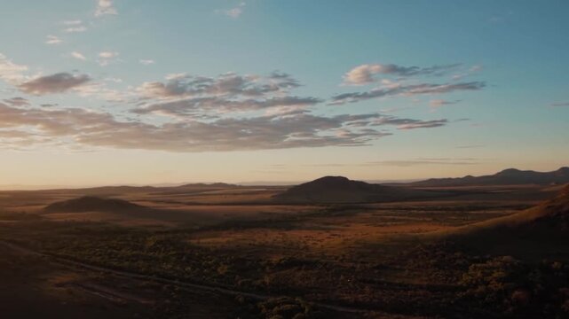 Chapada dos Veadeiros plateau extends across open Cerrado terrain with isolated rocky ridges, broad plains and agricultural fields in the Alto Paraiso region of Goias, pan