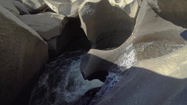 Vale da Lua features flowing water moving through smooth weathered quartzite channels and rounded cavities along the Sao Miguel River in the Cerrado of Chapada dos Veadeiros, slow motion