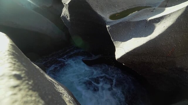 Vale da Lua water flow rushes through smooth eroded quartzite channels and rounded cavities along the Sao Miguel River in Chapada dos Veadeiros, Alto Paraiso de Goias, slow motion