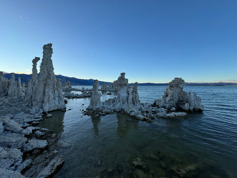Mono Lake tufa towers beside blue water at dusk