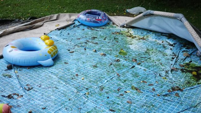 Deflated or Broken Pool Series - Deflated Pool in Side Yard of Home