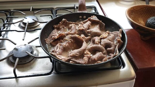 Beef Steak Chop Sizzling and Cooking in Hot Frying Pan