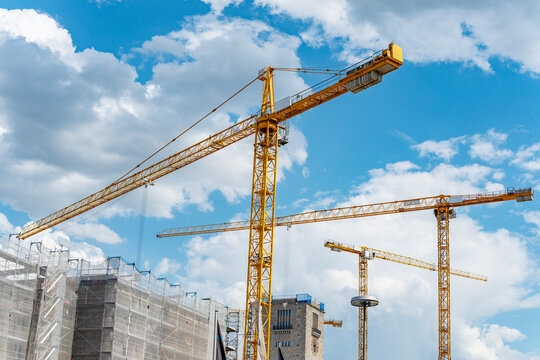 Industrial zone. Building and construction. Hoisting crane. Construction at building site with crane. Construction crane at building area. Construction site with building crane