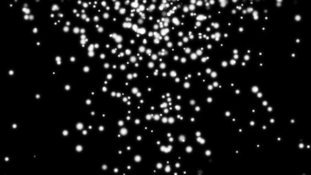 Floating white particles falling downwards against dark black background motion graphic footage showing soft glowing bokeh circles descending slowly in a seamless loop animation.