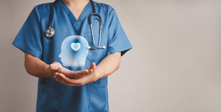 Healthcare professional doctor gently supports head and heart symbol. Compassionate mental health care, emotional wellbeing, behavioral health, holistic support and patient-centered wellness concepts.