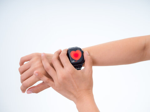 Person checks smartwatch displaying heart rate data at 98 BPM on white background. Wearable health monitoring, biometric tracking, fitness technology and personal wellness management concept.