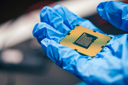 young female tech electronics engineer inspecting a CPU as a conceptual backdrop for artificial intelligence hardware technology innovation quality control