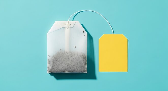 Single unused tea bag with a blank yellow label from above