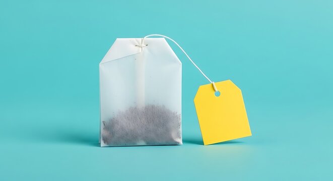 Single unused tea bag with a blank yellow label standing
