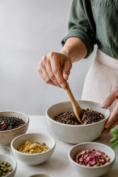Hands Measuring Loose Leaf Tea for Artisan Blend