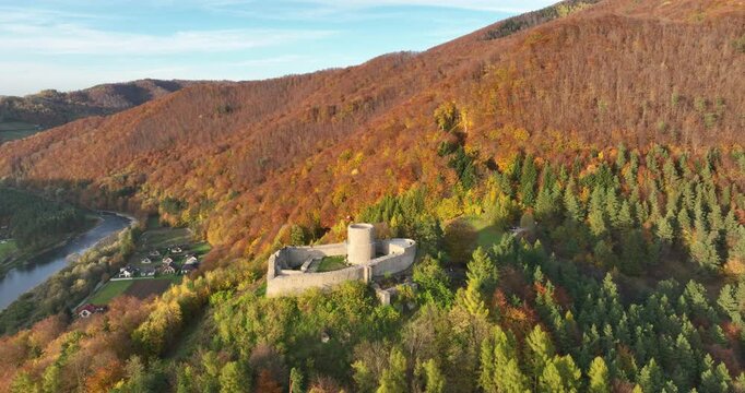Aerial flyover toward Rytro Castle ruins in the autumn Poprad valley