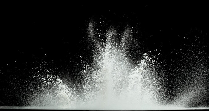 Tapioca starch flour fly explosion, White powder tapioca starch fall down in air. Seasoning flour powder is element material. Eyeshadow crush make up. Black background Isolated selective focus blur