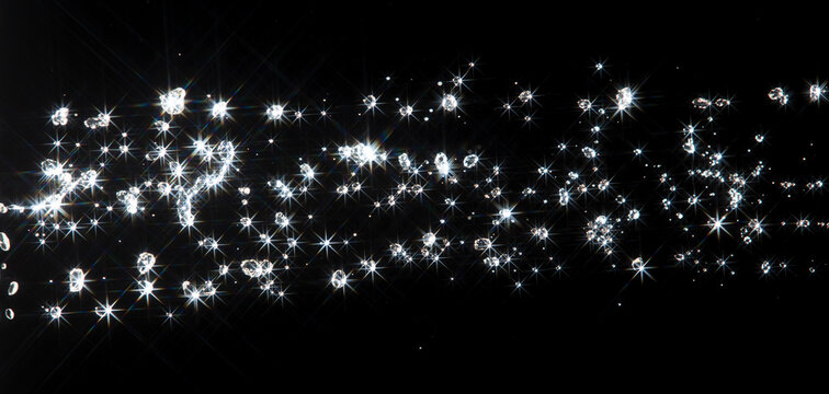 Shining water created sparkling splash with bright reflections and starburst flare, like  star in light. Water Glitter from splash caught light, creating abstract sparkling scene with star flare
