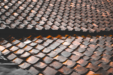 Texture of a traditional clay tile roof that is wet after being hit by rain © Hendri