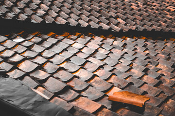 Texture of a traditional clay tile roof that is wet after being hit by rain © Hendri