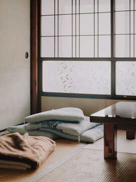 Traditional Japanese tatami room interior with shoji screens and floor cushions