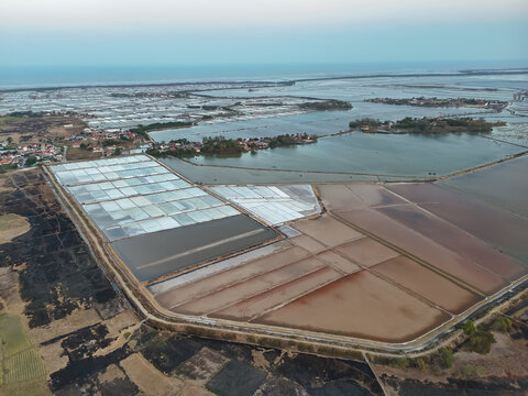 Aerial Landscape View of Coastal Salt Pans, Aquaculture Ponds, and Ocean Horizon